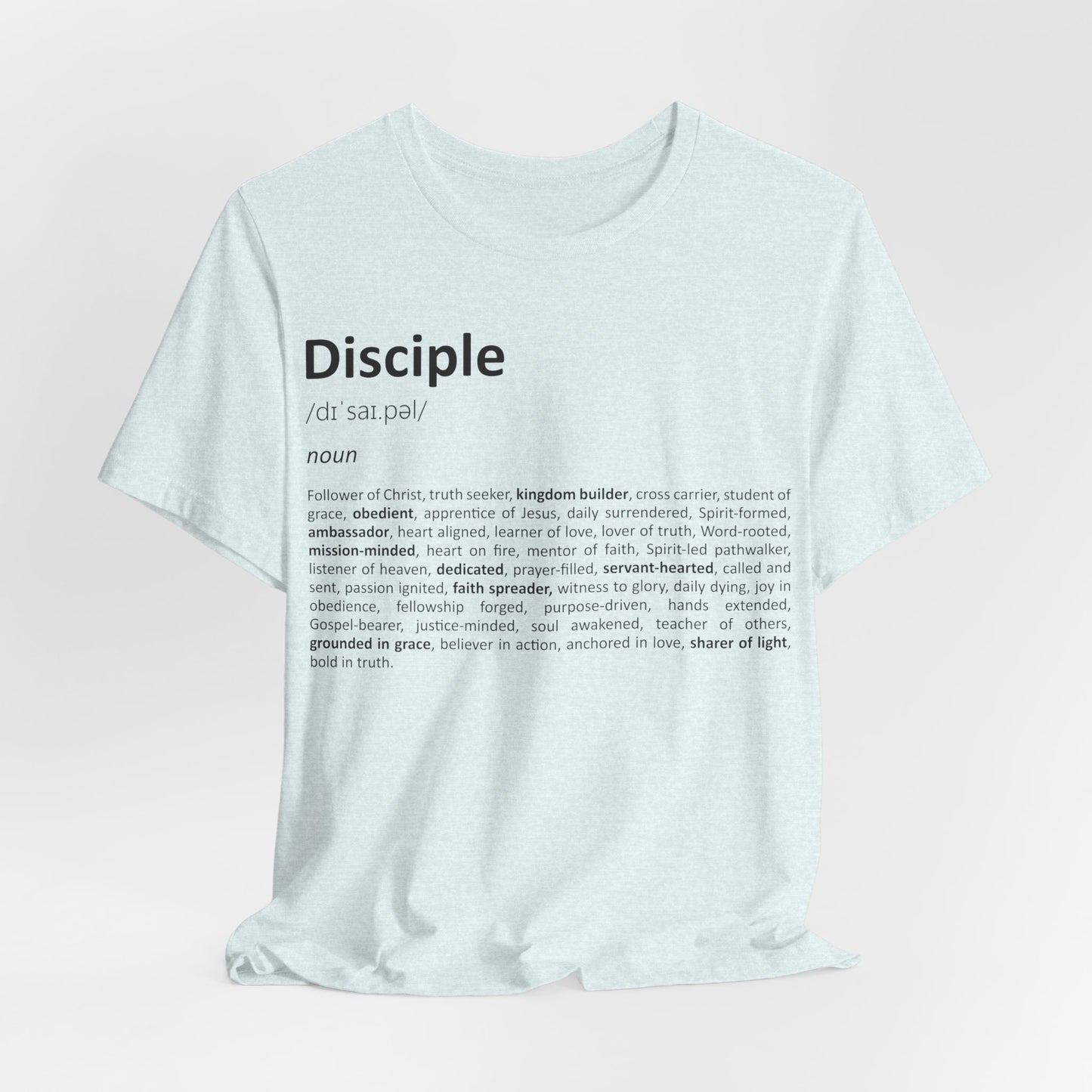 White t-shirt with black text on a light pink background
