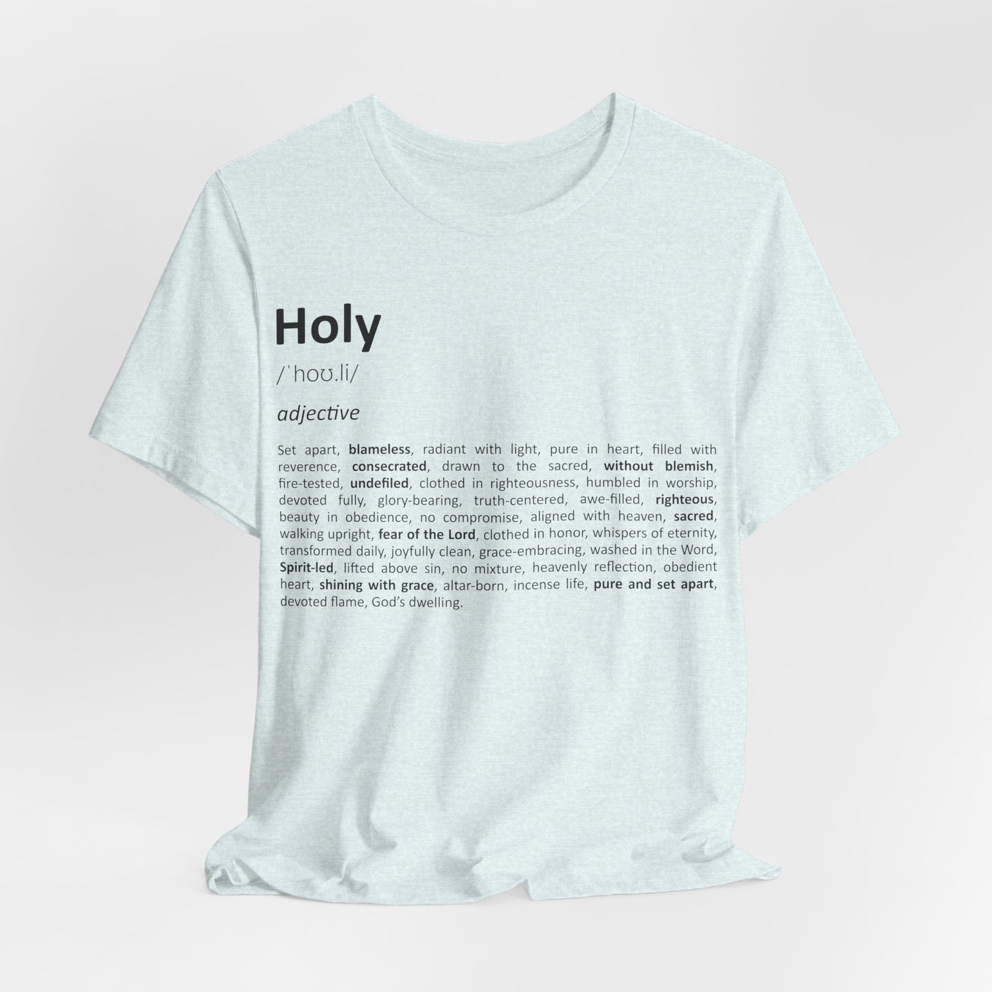 White t-shirt with black text on a light pink background