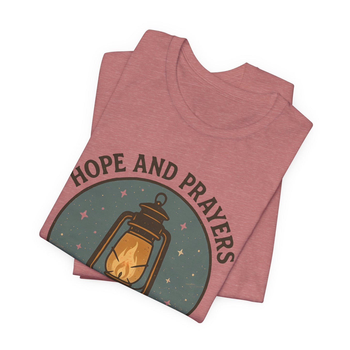 Stack of pink t-shirts with 'Hope and Prayers' design on a white background