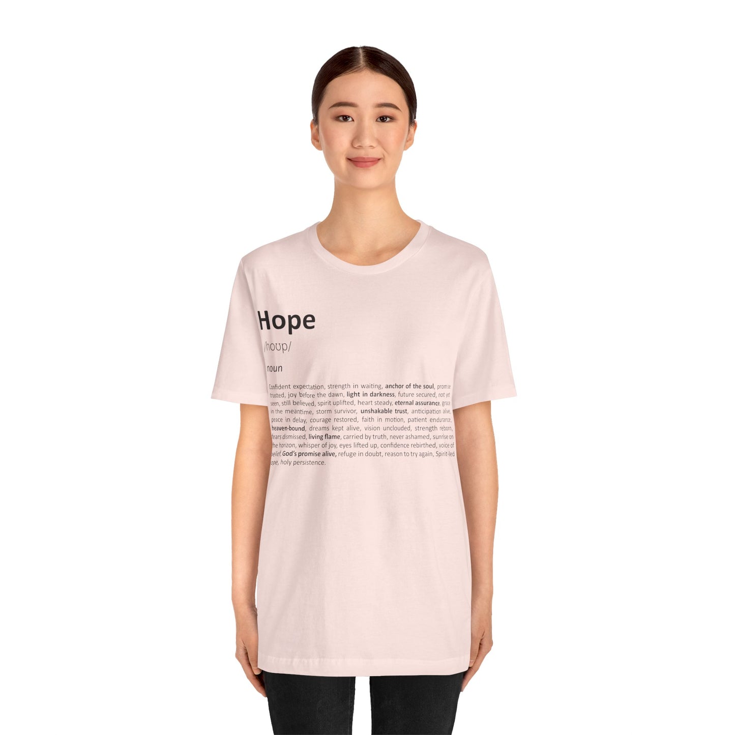 Person wearing a light pink t-shirt with 'Hope' printed on it against a white background