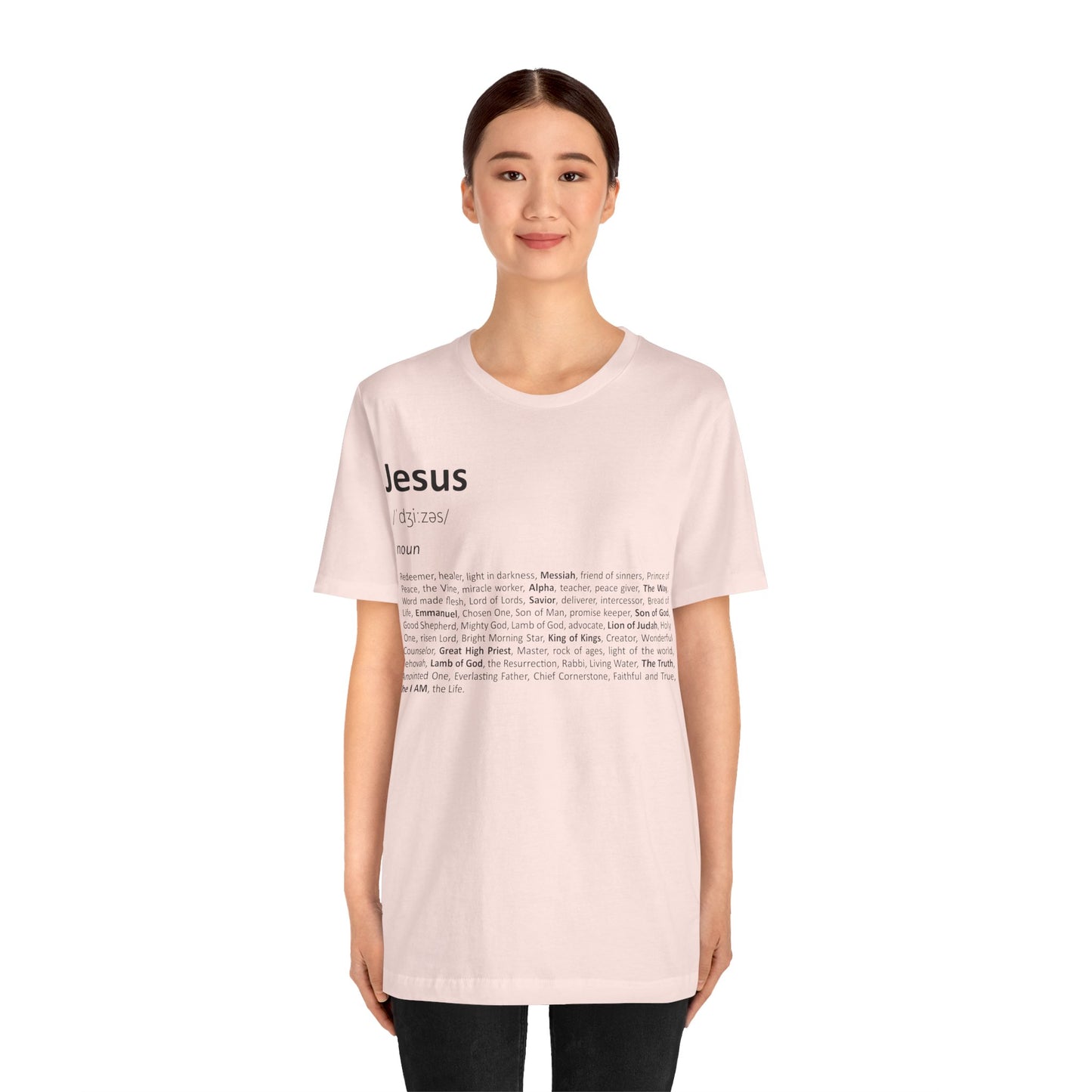 Person wearing a light pink t-shirt with text on a white background
