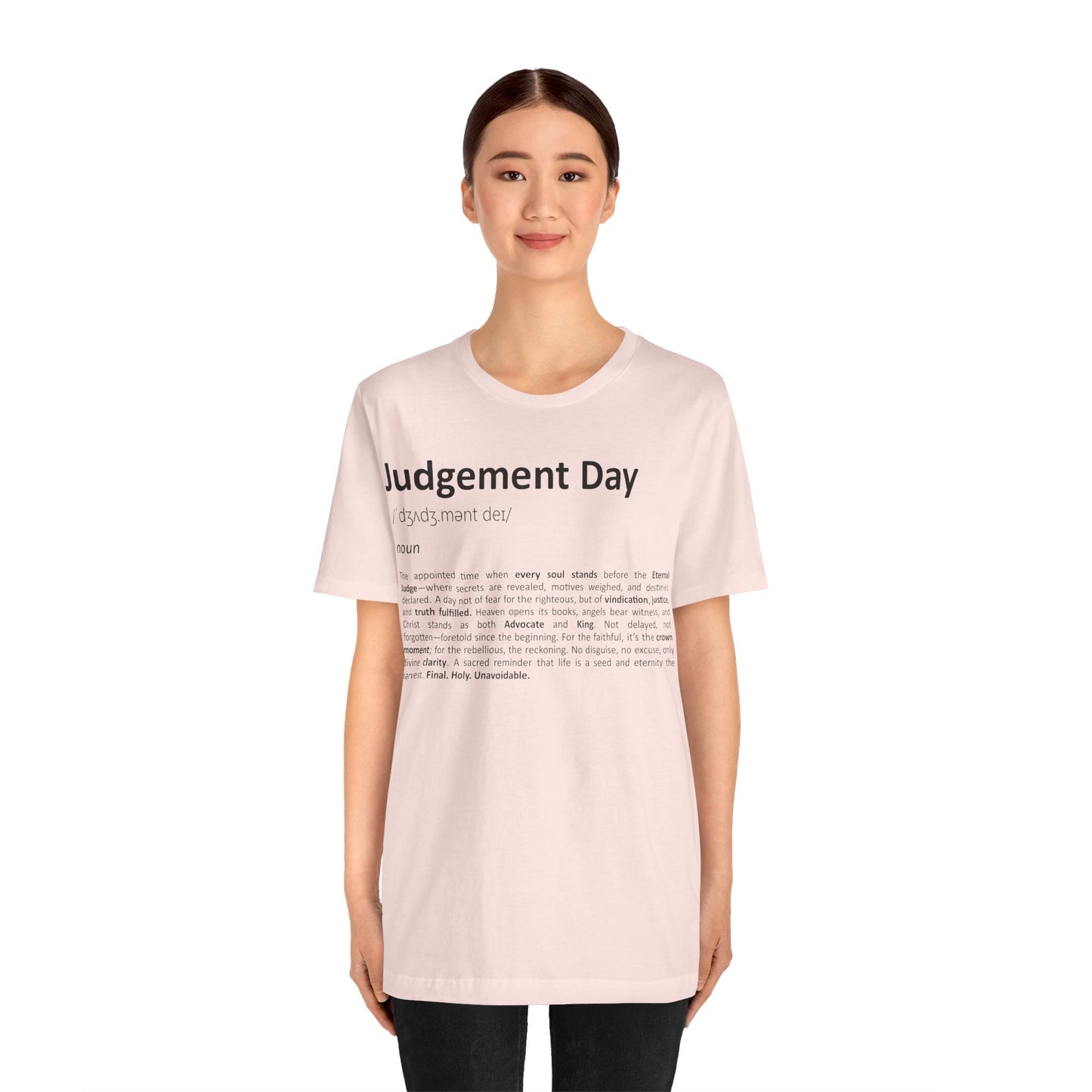 Person wearing a light pink t-shirt with text on a white background