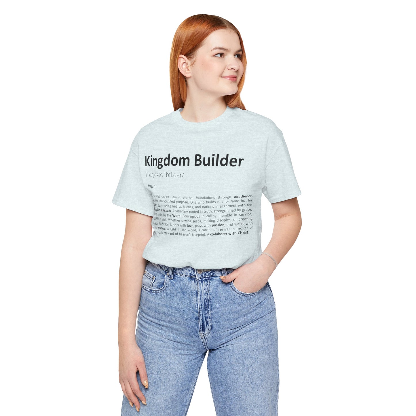 Person wearing a light blue t-shirt with 'Kingdom Builder' text on a white background