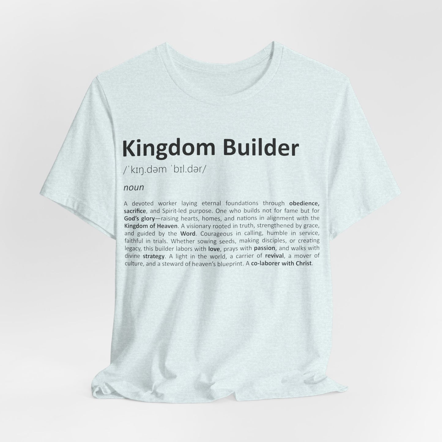 White t-shirt with 'Kingdom Builder' definition text on a light pink background
