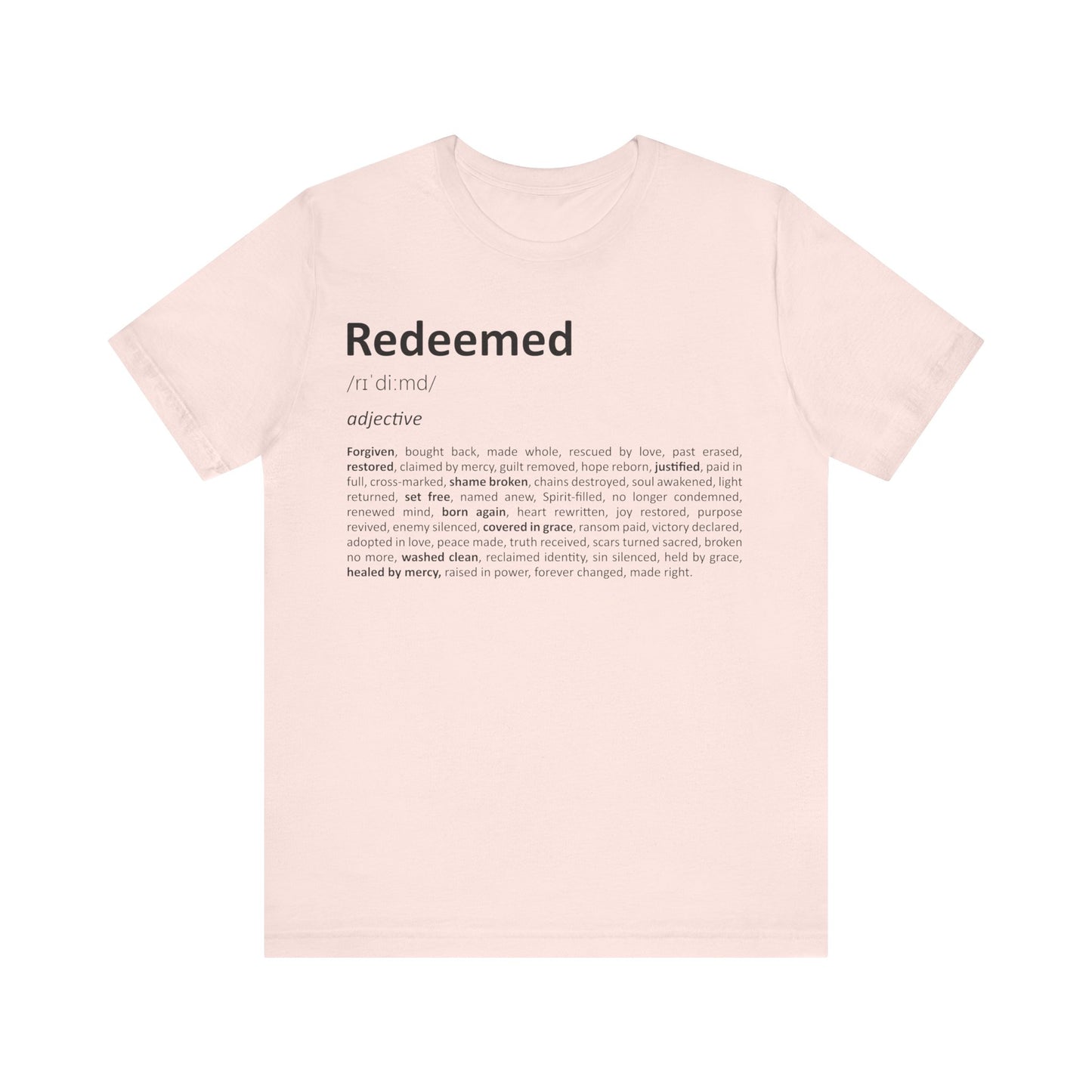 Pink t-shirt with 'Redeemed' definition text on a white background