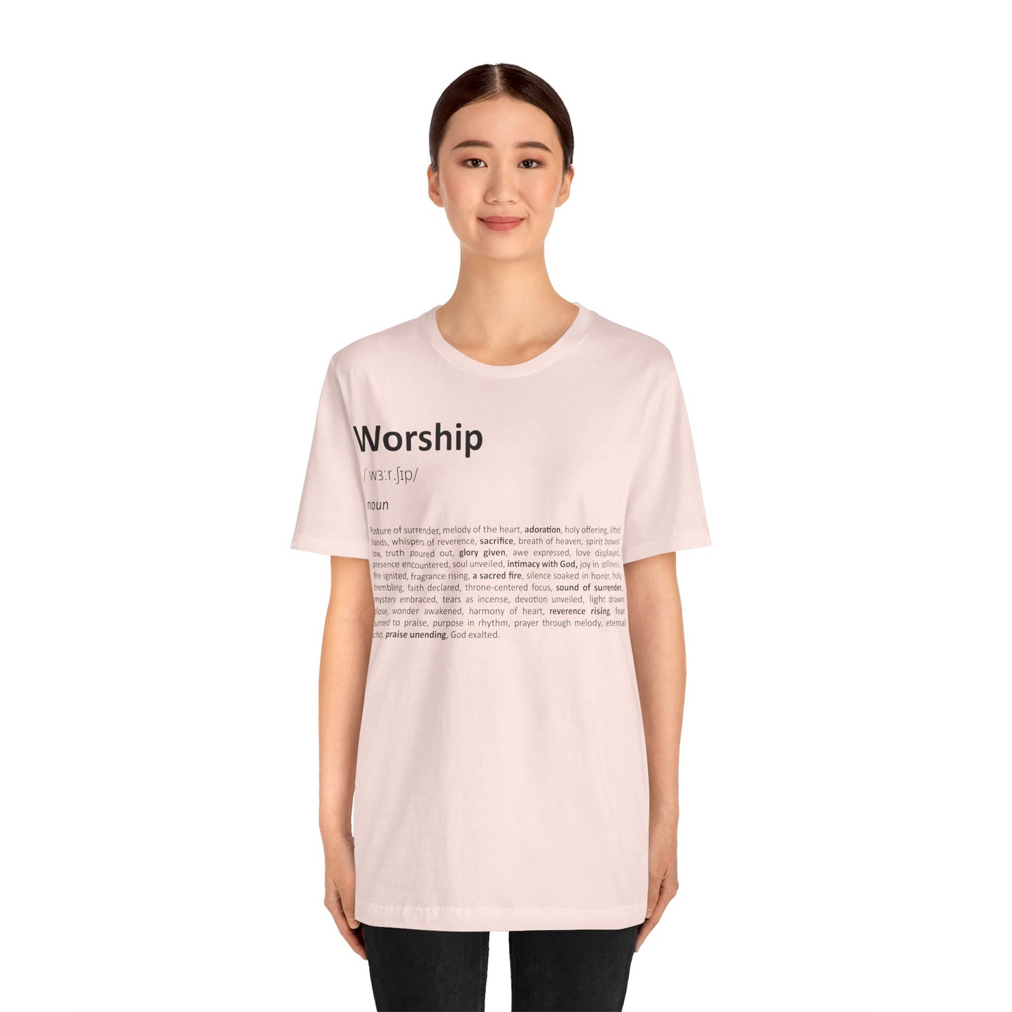 Person wearing a light pink t-shirt with text on a white background