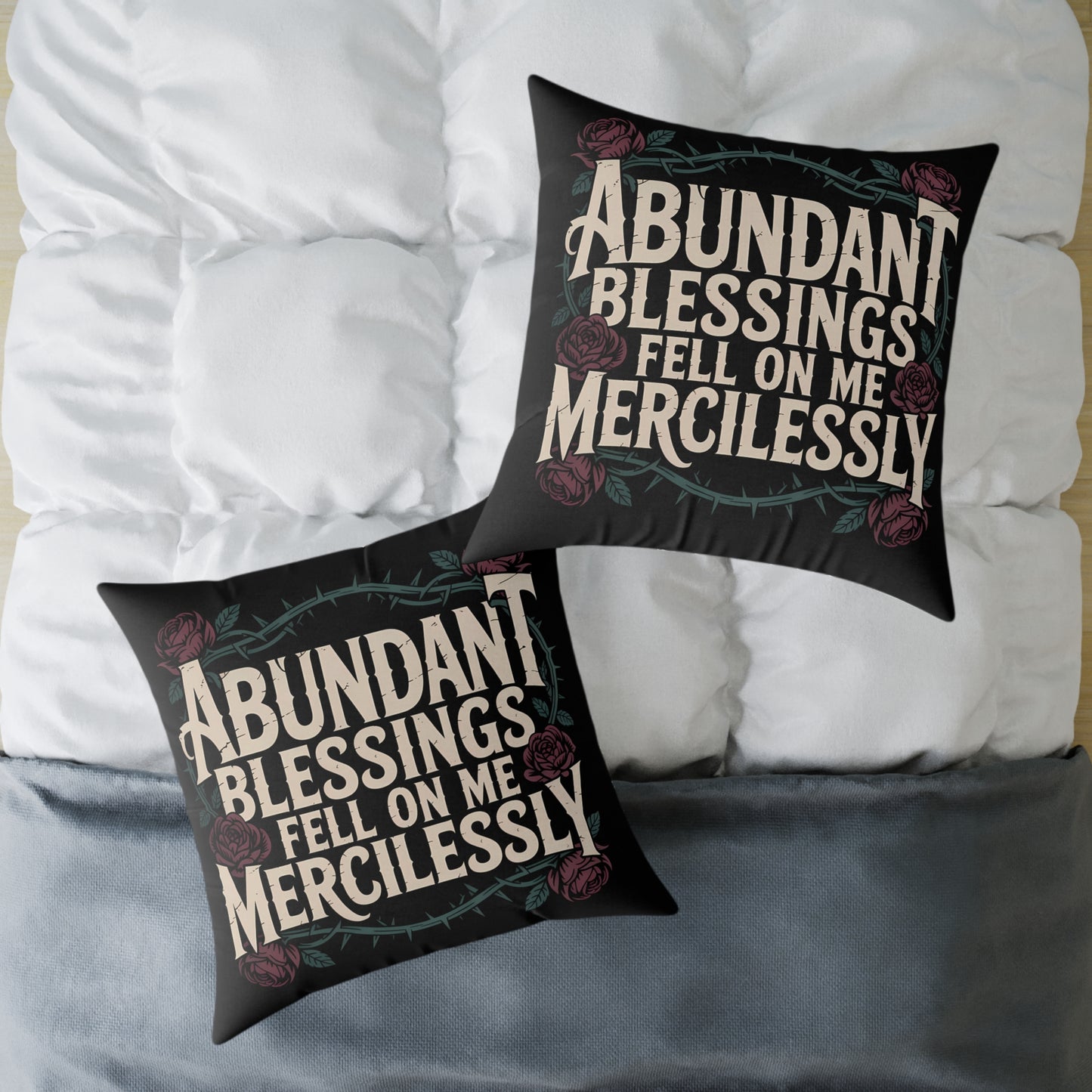 Two black pillows with white text on a white surface