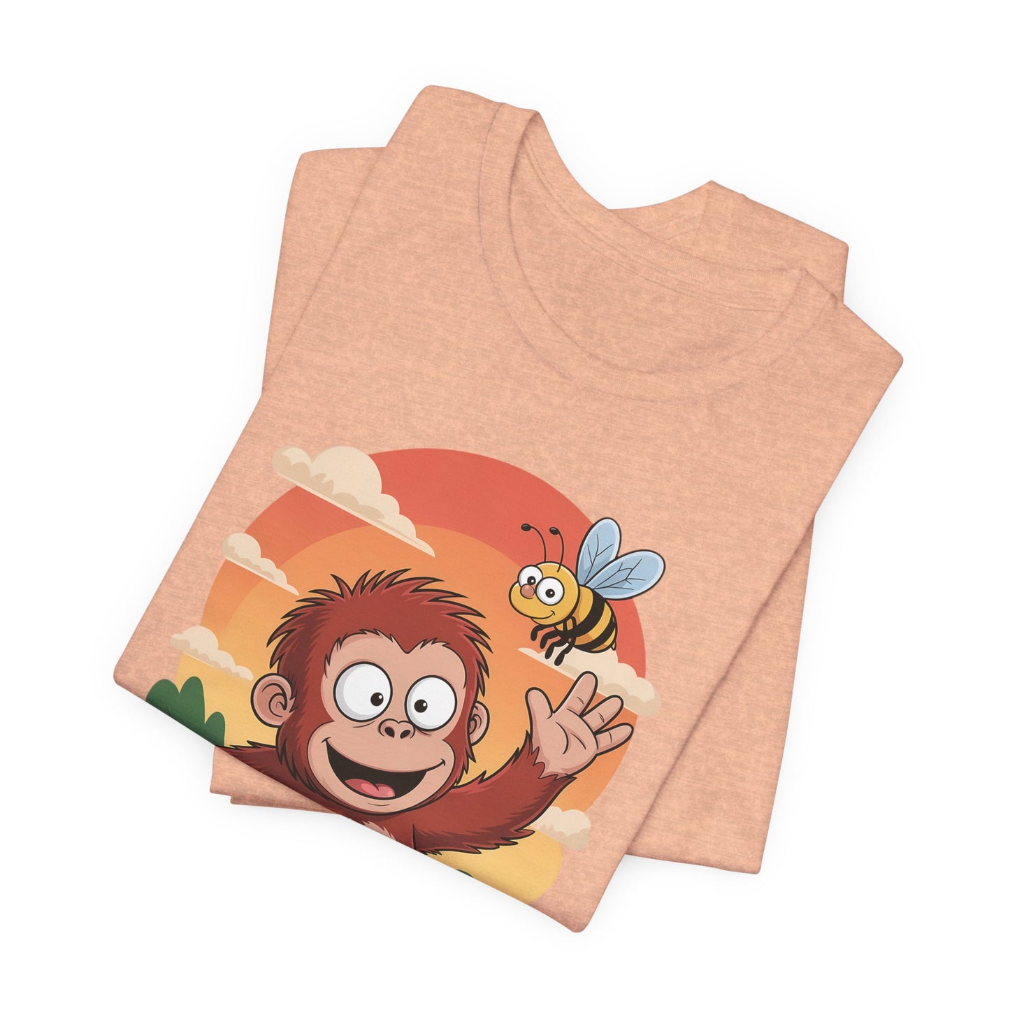 Folded peach-colored t-shirt with a monkey and bee design on a white background