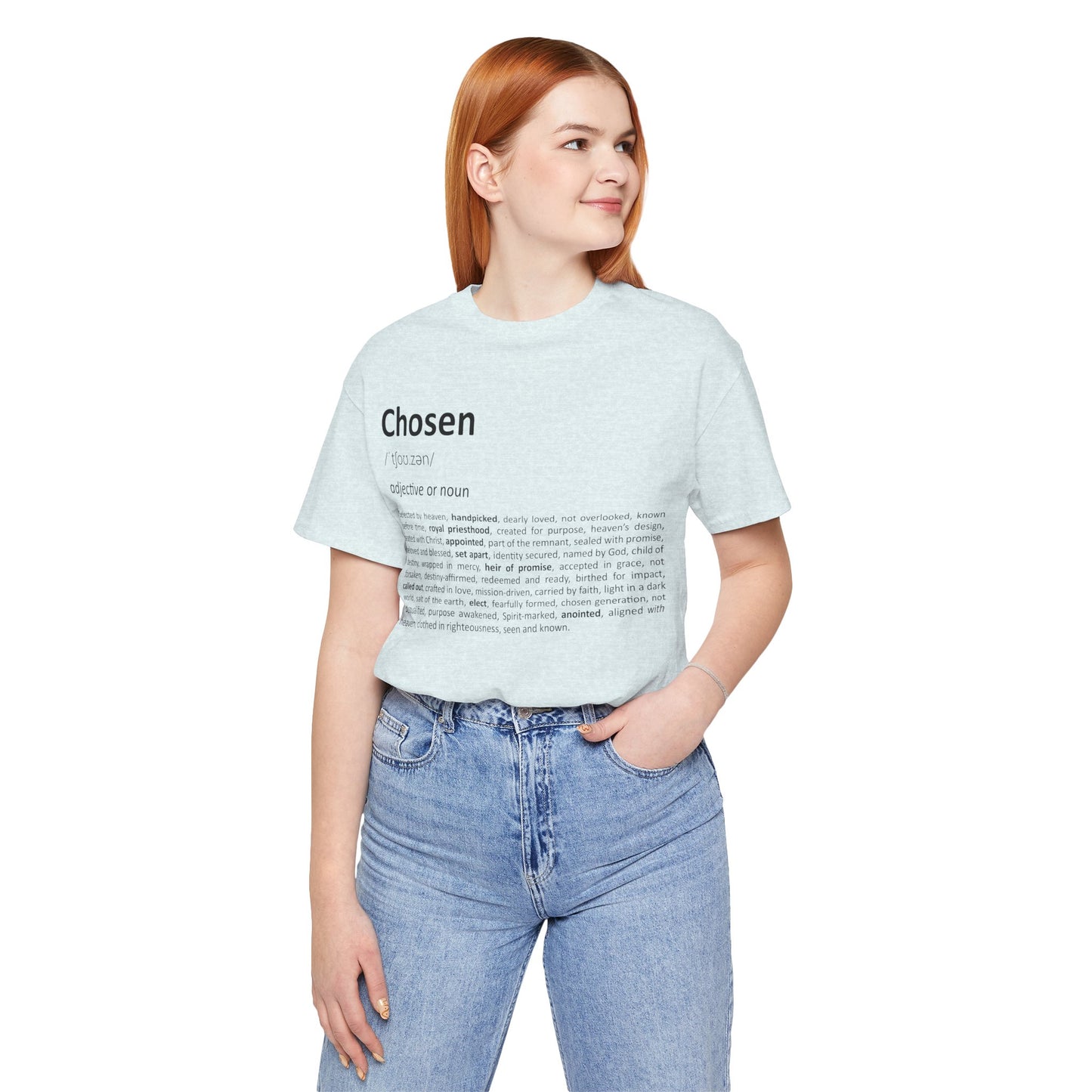 Woman wearing a light blue t-shirt with text, standing against a white background
