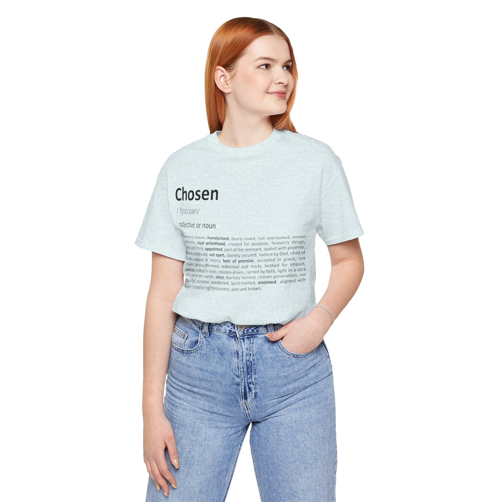 Woman wearing a light blue t-shirt with text, standing against a white background