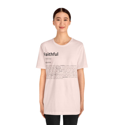 Person wearing a light pink t-shirt with text on a white background