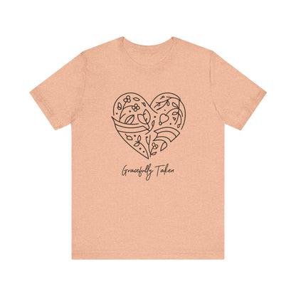 Beige t-shirt with a heart design and text on a white background