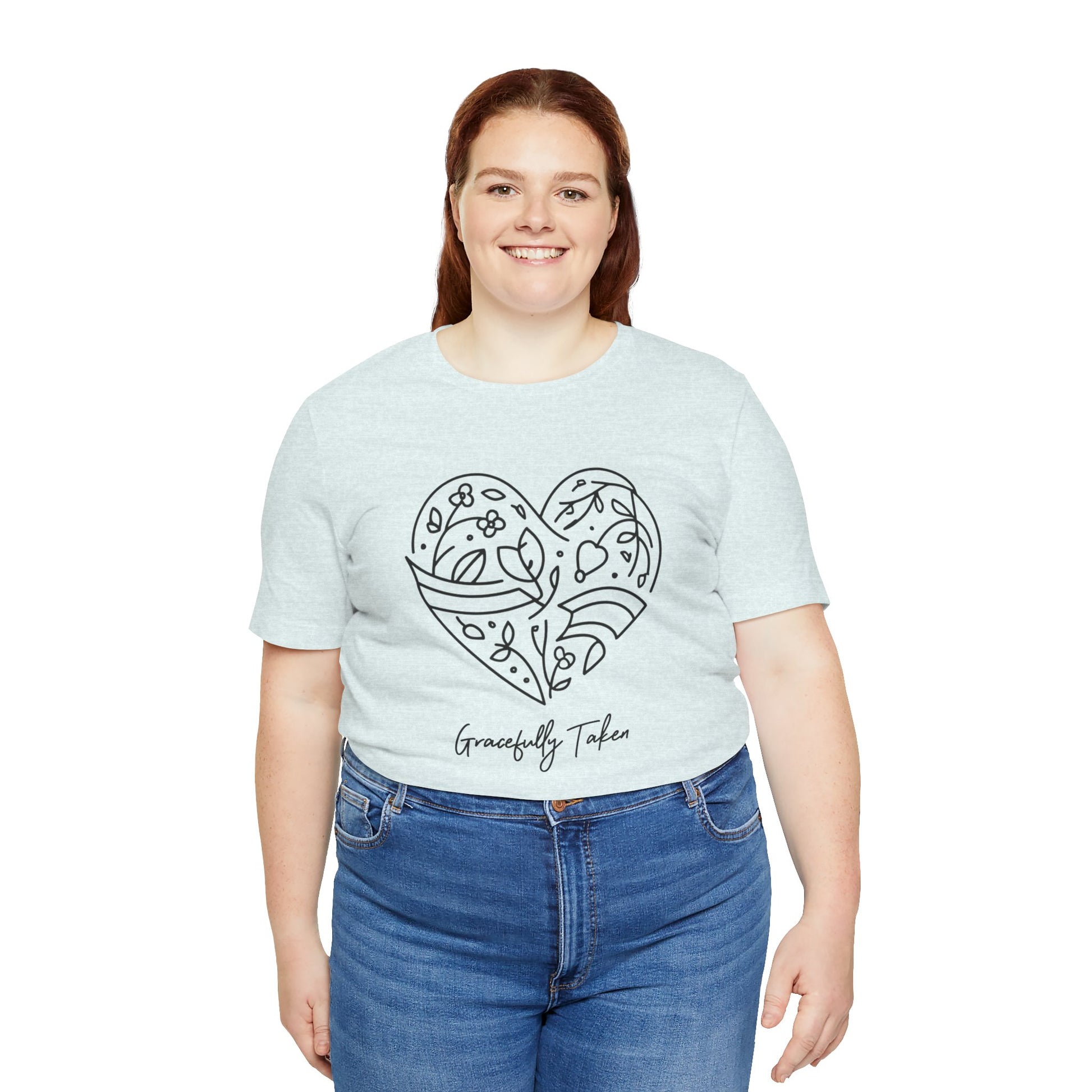 Person wearing a light blue t-shirt with a heart design and text on a white background