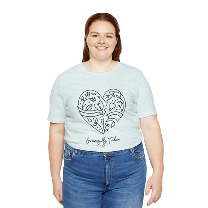 Person wearing a light blue t-shirt with a heart design and text on a white background