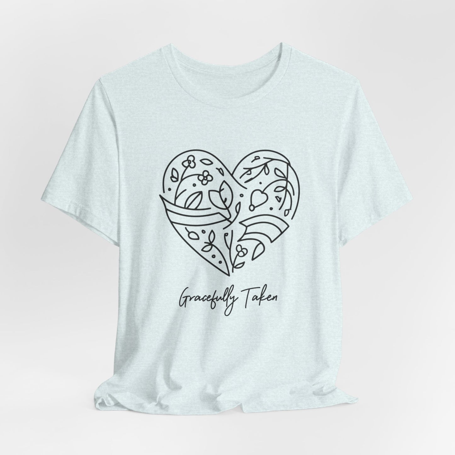 Light blue t-shirt with a heart design and 'Gracefully Taken' text on a light pink background