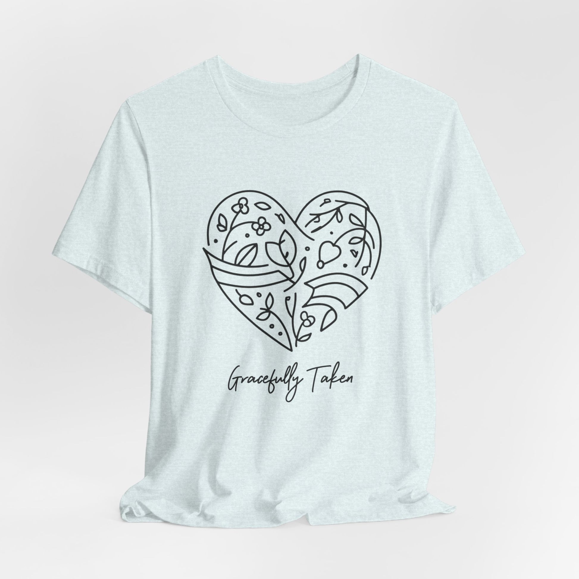 Light blue t-shirt with a heart design and 'Gracefully Taken' text on a light pink background
