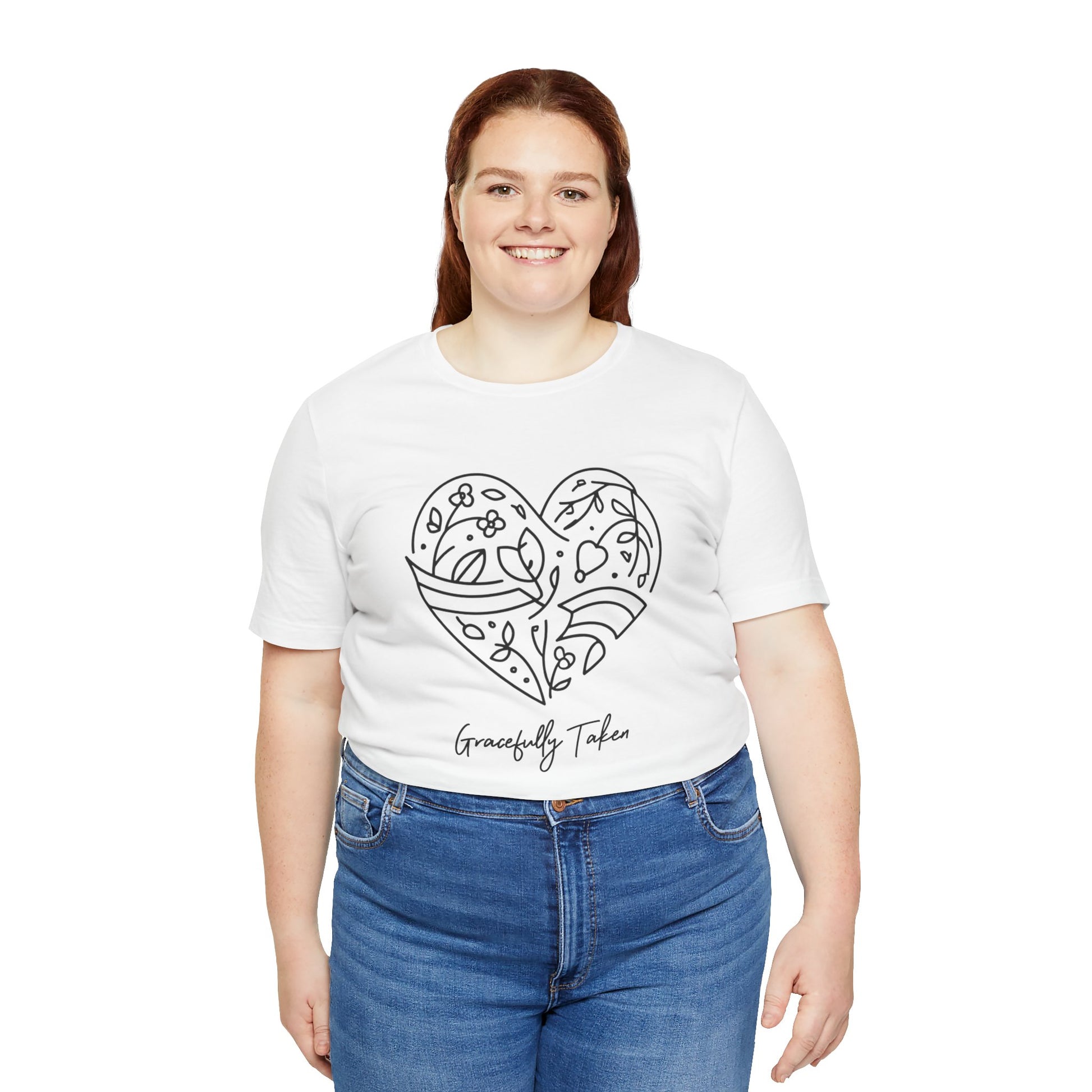 Person wearing a white t-shirt with a heart design and text, standing against a white background