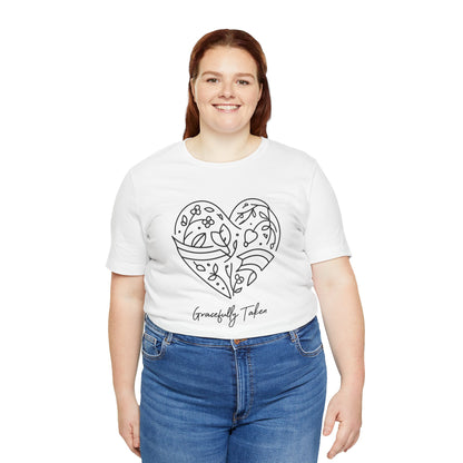 Person wearing a white t-shirt with a heart design and text, standing against a white background
