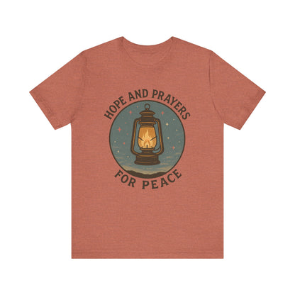 Red t-shirt with a lantern graphic and text 'Hope and Prayers for Peace' on a white background
