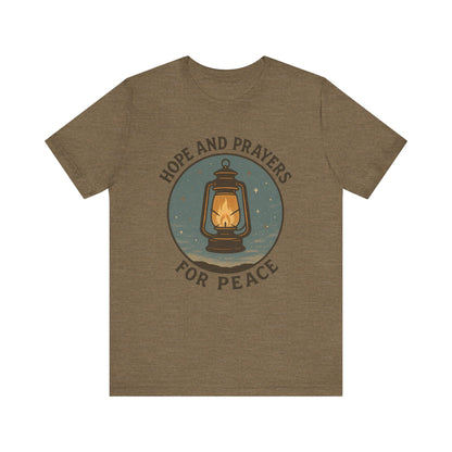 Brown t-shirt with a lantern graphic and text 'Hope and Prayers for Peace' on a white background