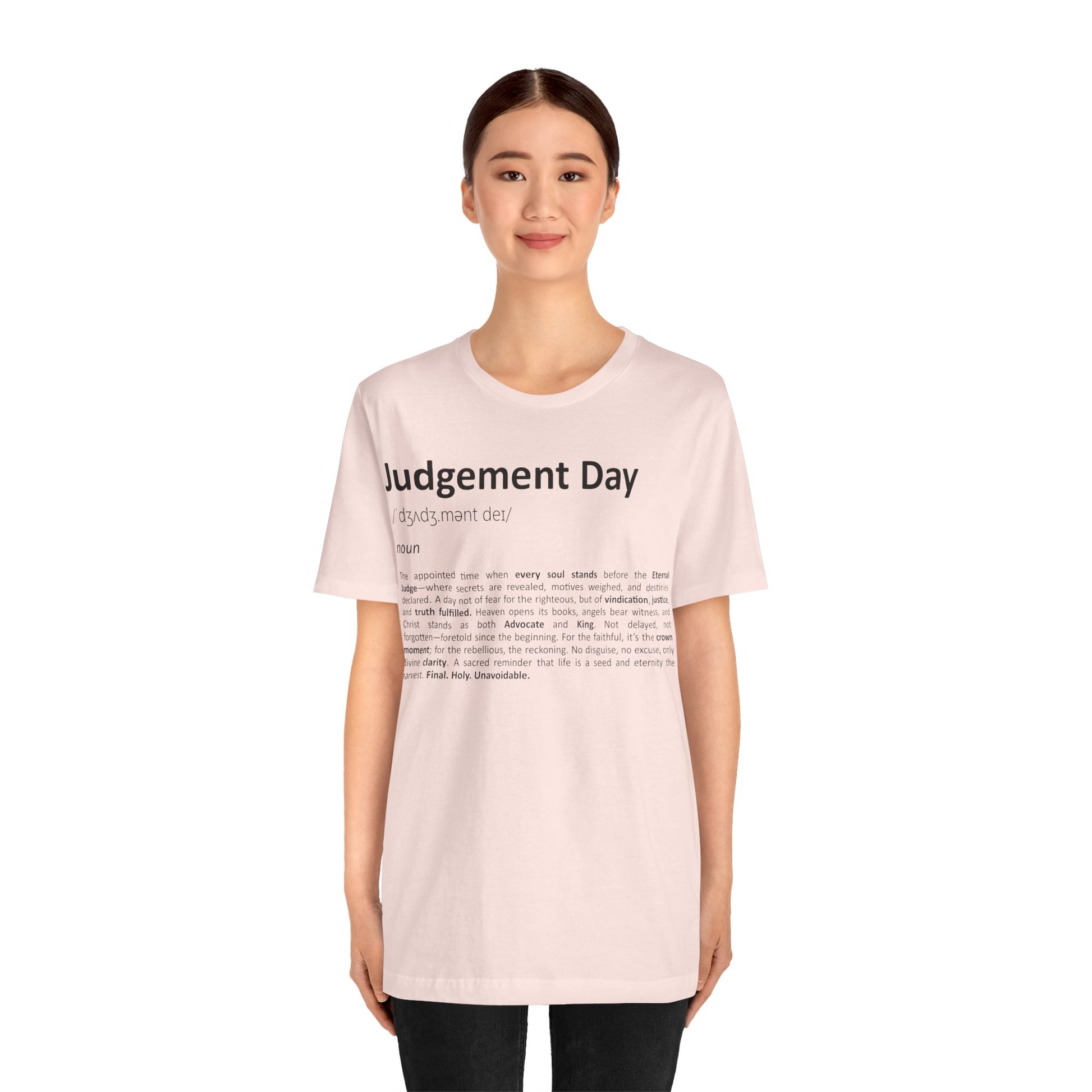 Person wearing a light pink t-shirt with text on a white background