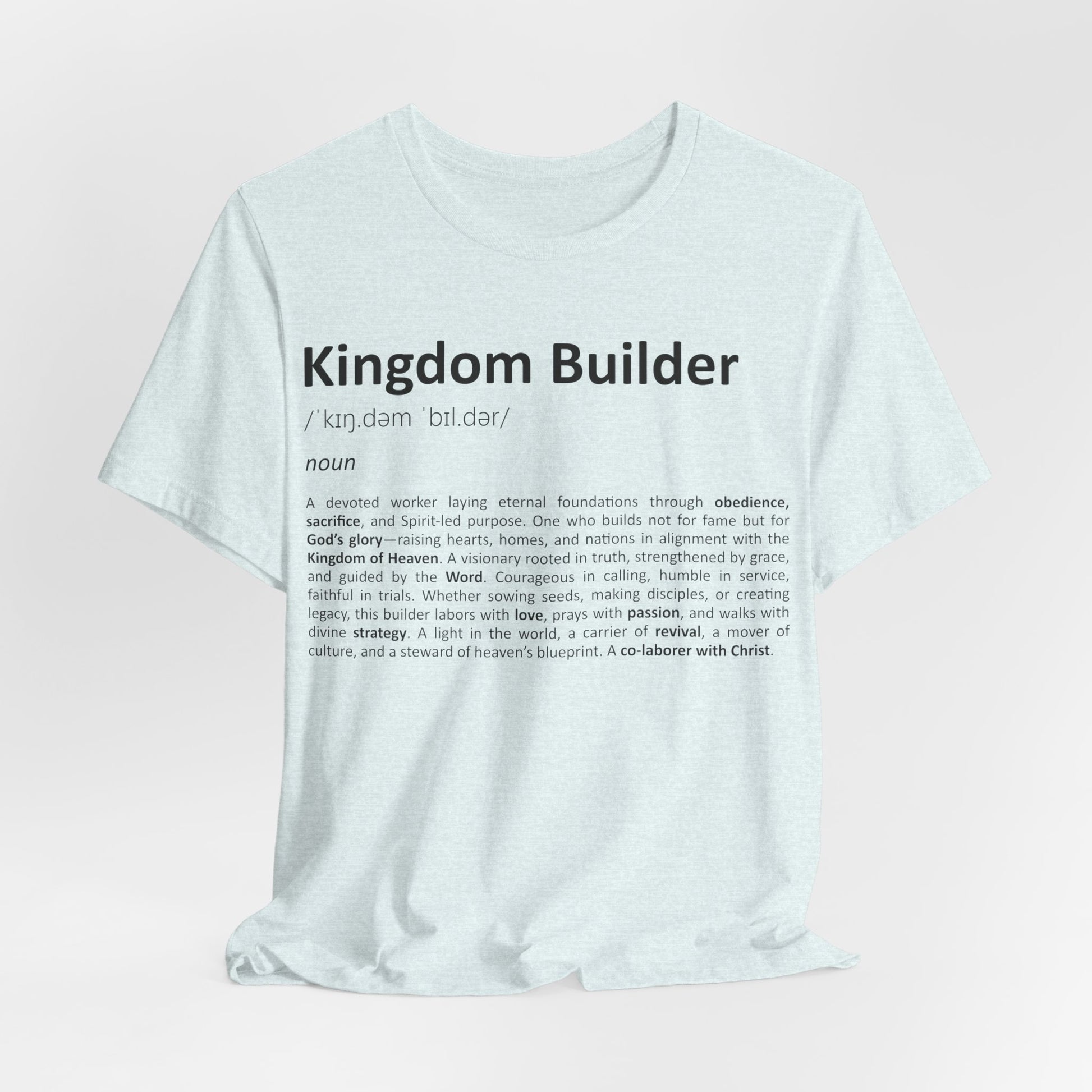 White t-shirt with 'Kingdom Builder' definition text on a light pink background