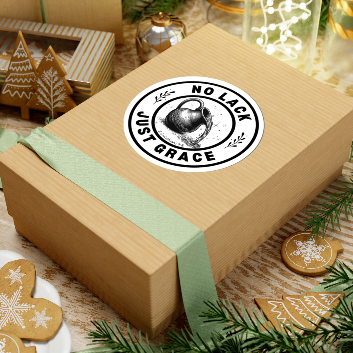 Wooden gift box with a green ribbon and 'No Lack Just Grace' stamp on a festive background with cookies and lights.