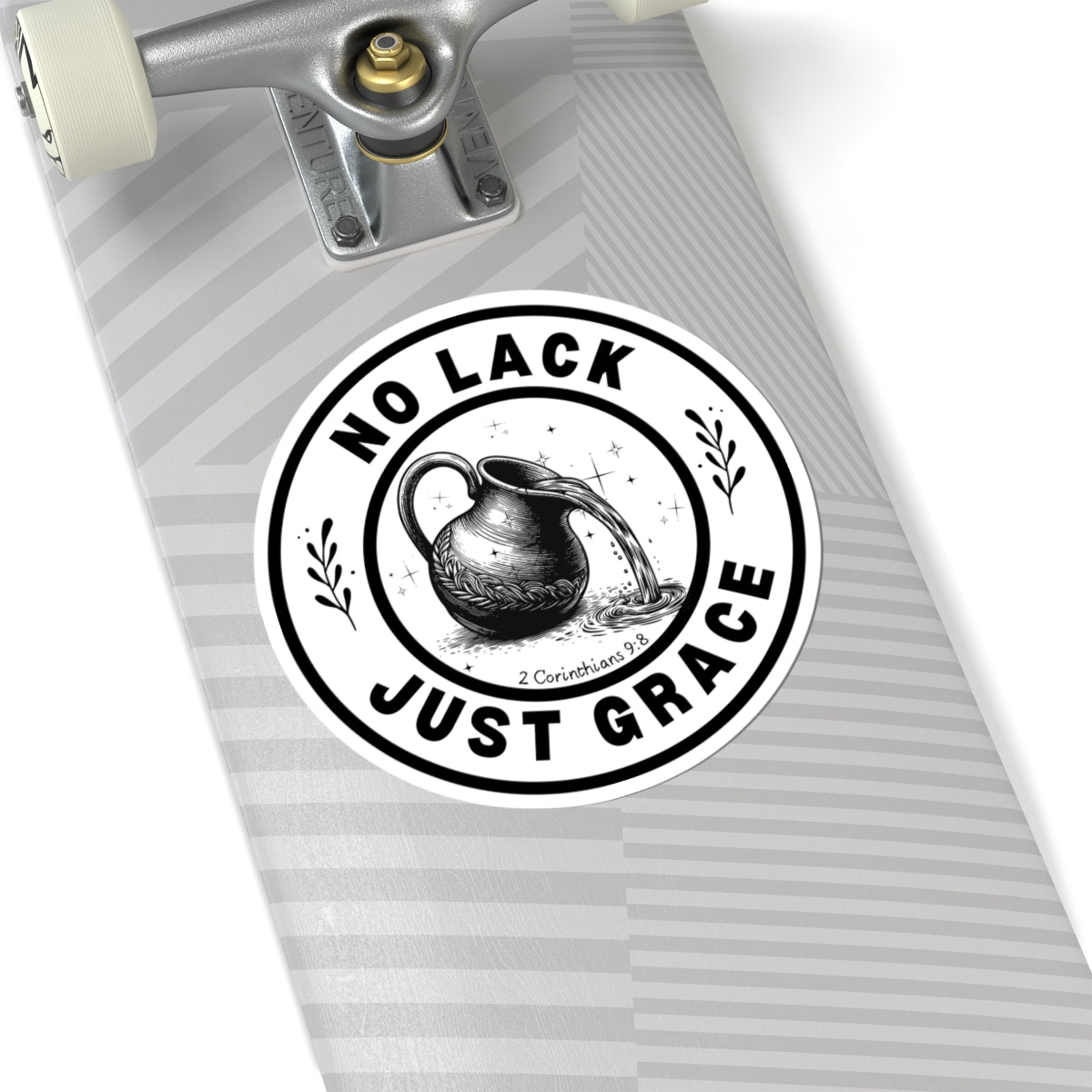 Skateboard with a 'No Lack Just Grace' sticker on a white background