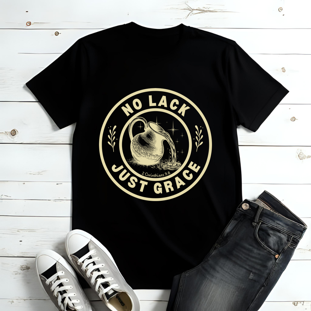 Black t-shirt with 'No Lack Just Grace' design on a wooden surface with jeans and sneakers.