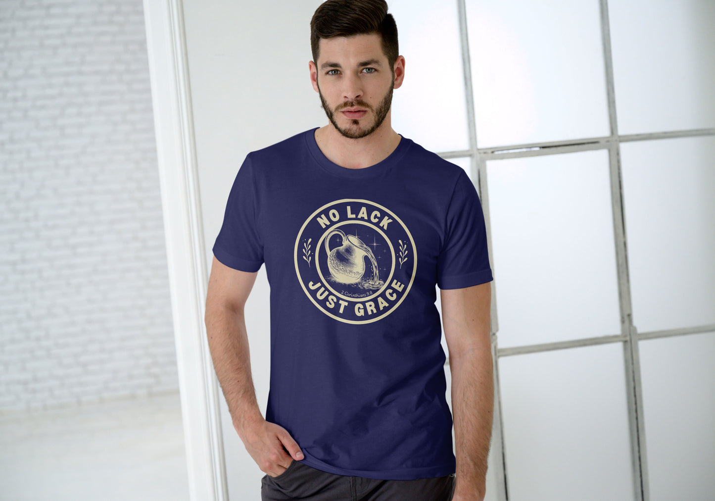 Man wearing a navy blue t-shirt with 'No Lack Just Grace' text design.