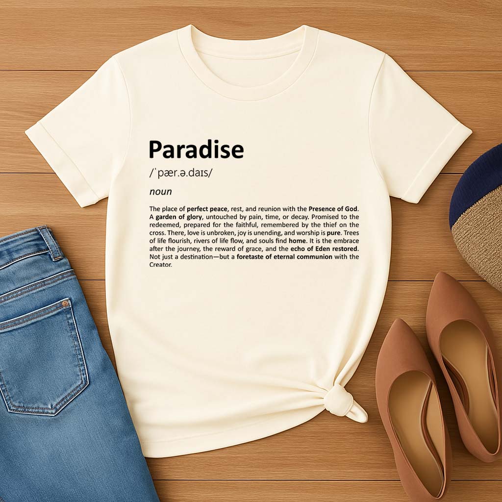 Cream t-shirt with 'Paradise' definition text on a wooden surface with jeans and shoes.