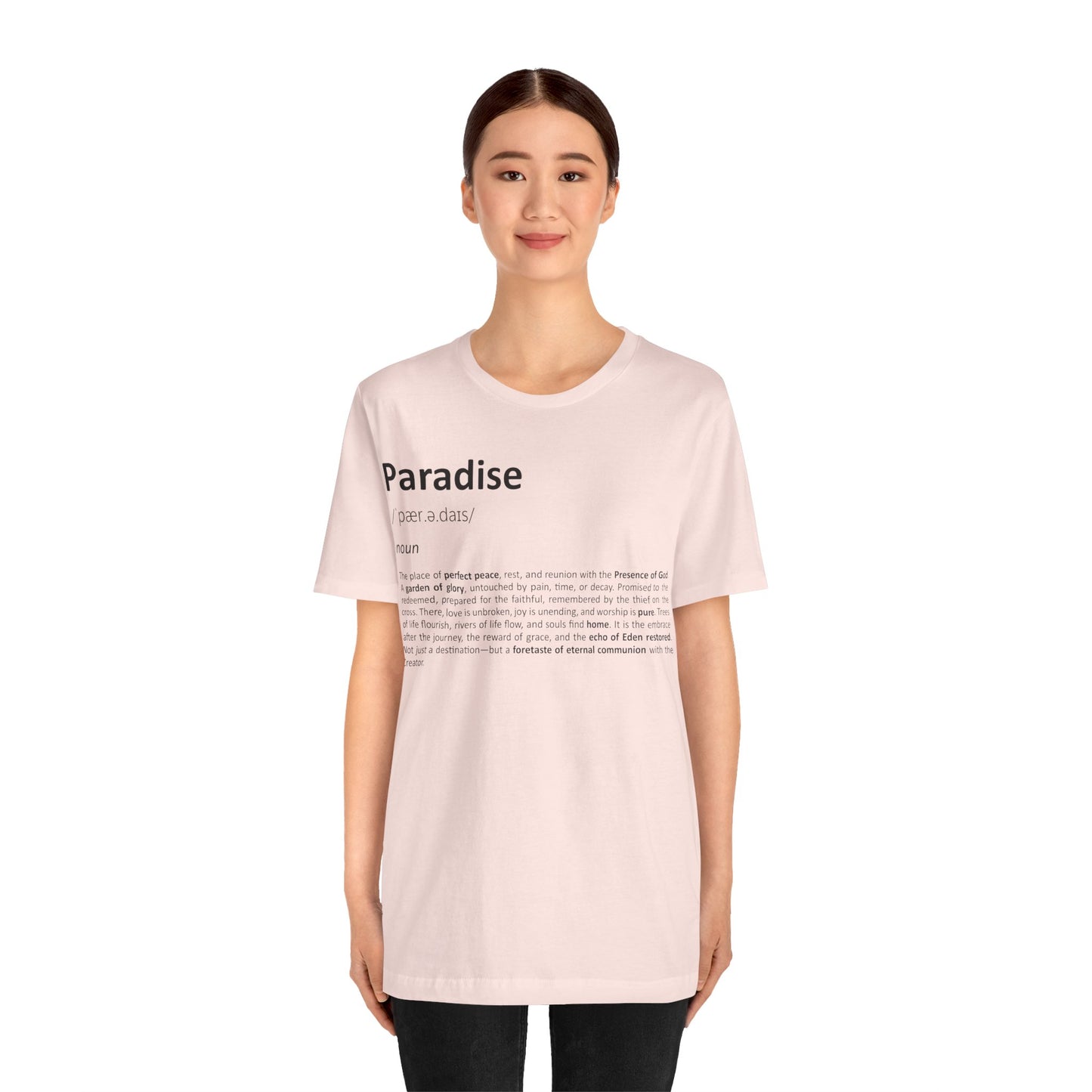 Person wearing a light pink t-shirt with text on a white background