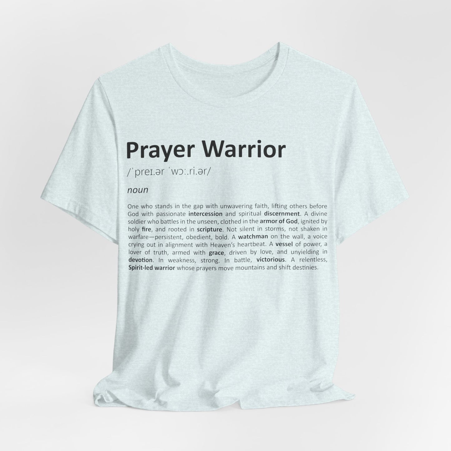 White t-shirt with 'Prayer Warrior' definition text on a light pink background