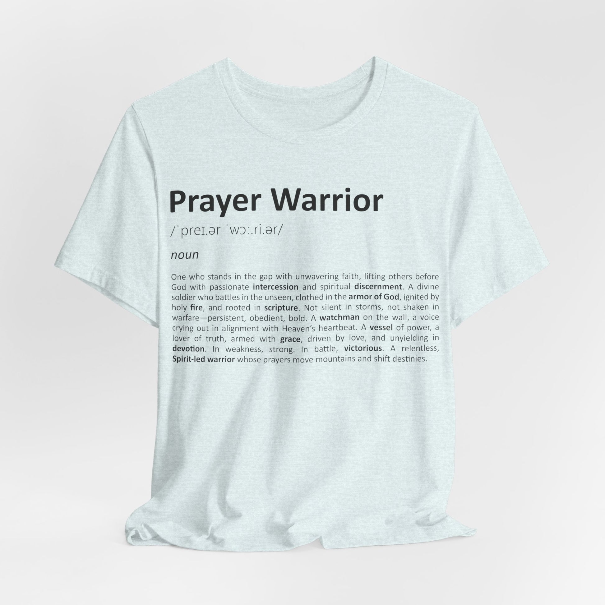White t-shirt with 'Prayer Warrior' definition text on a light pink background