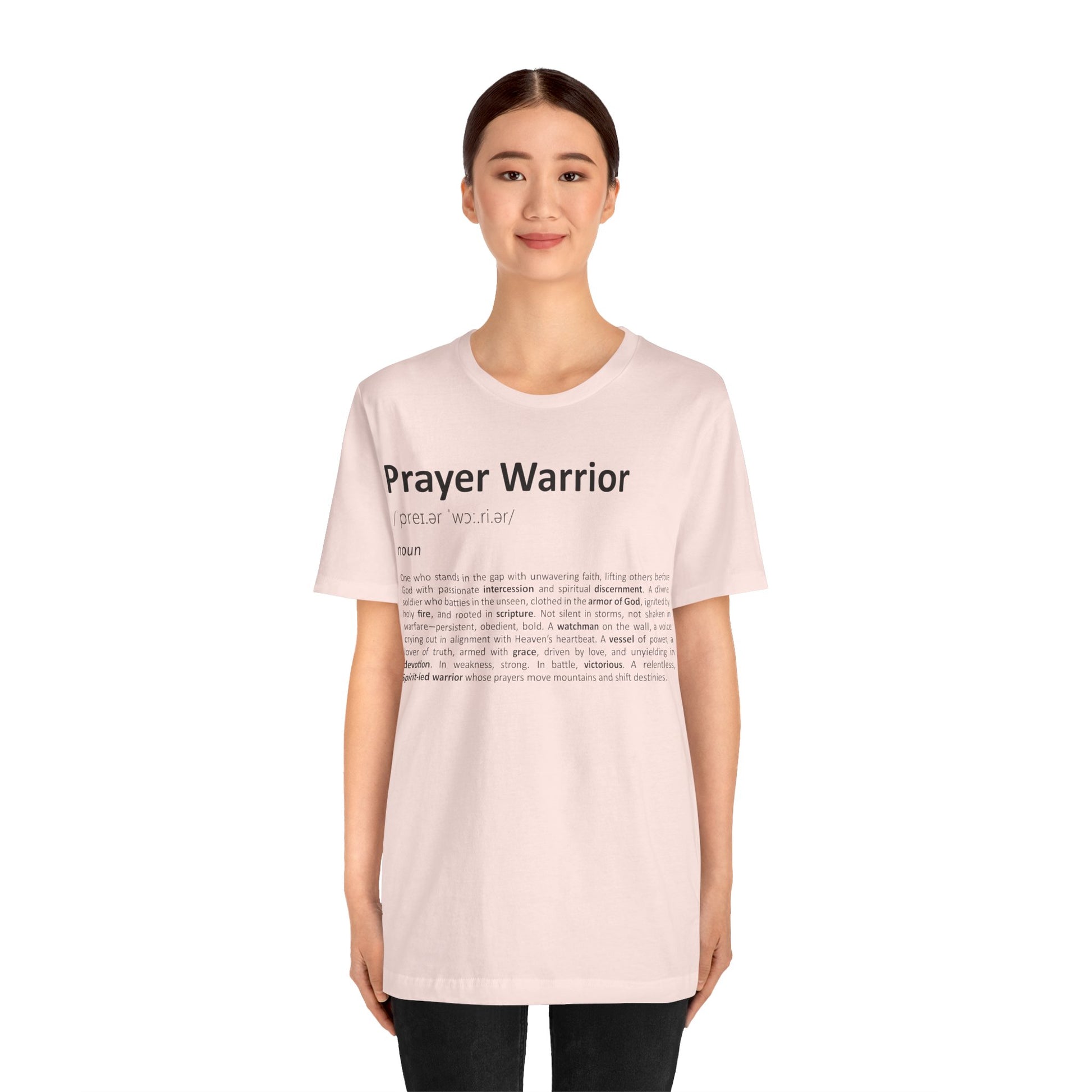 Person wearing a pink t-shirt with 'Prayer Warrior' text on a white background
