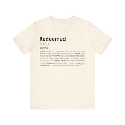 Beige t-shirt with 'Redeemed' definition printed on a white background