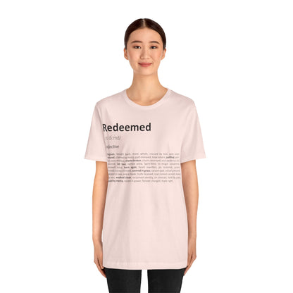 Person wearing a light pink t-shirt with text on a white background
