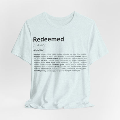 White t-shirt with 'Redeemed' definition text on a light pink background