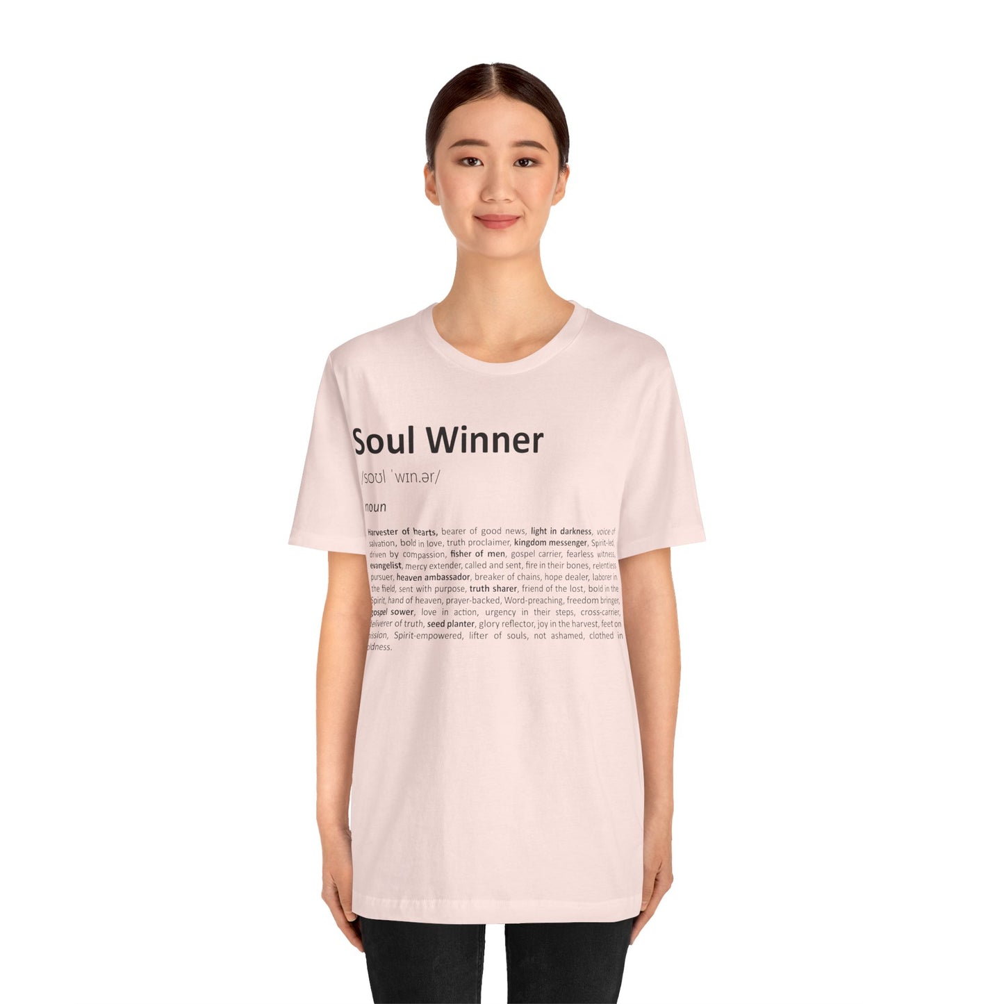 Woman wearing a light pink t-shirt with text on a white background