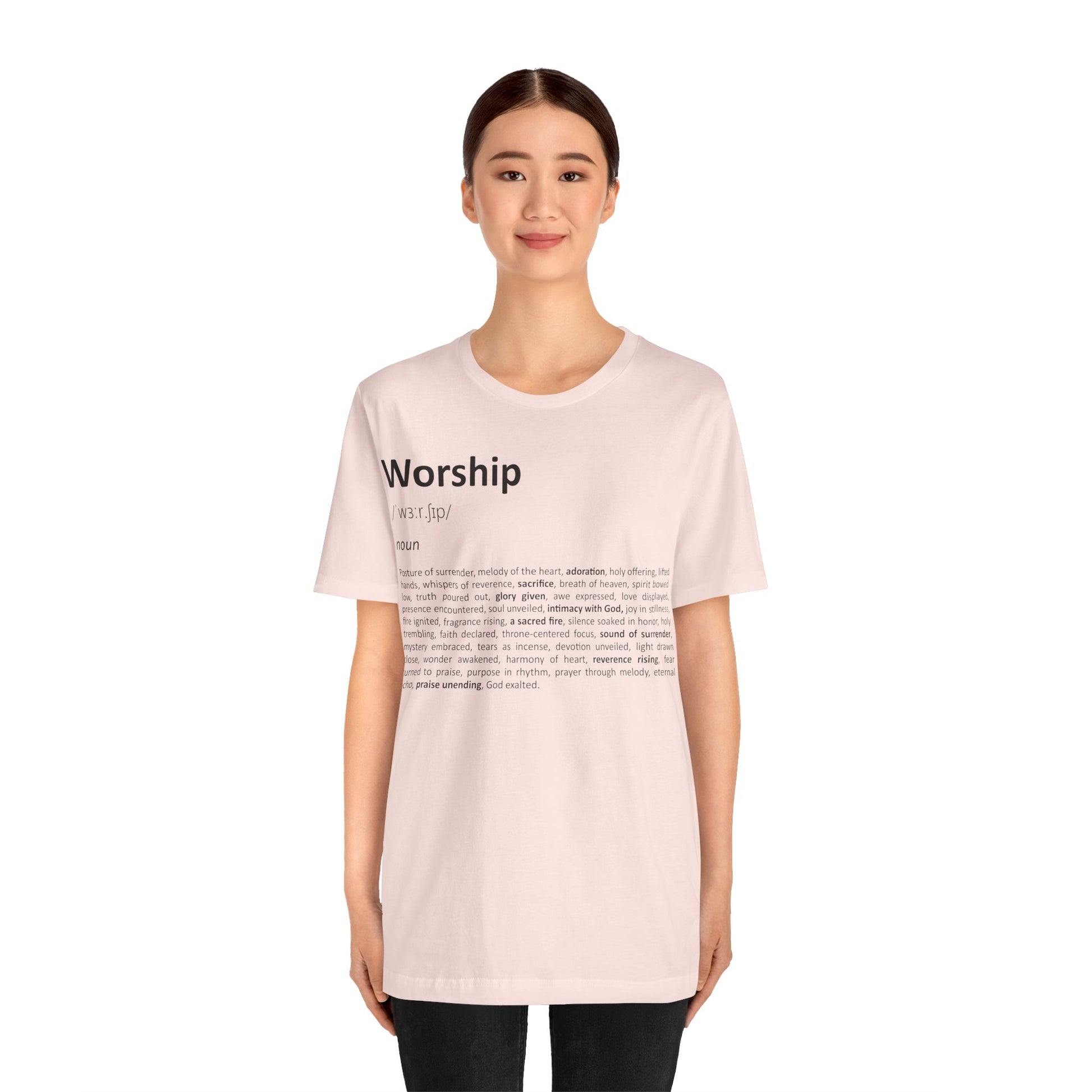 Person wearing a light pink t-shirt with text on a white background