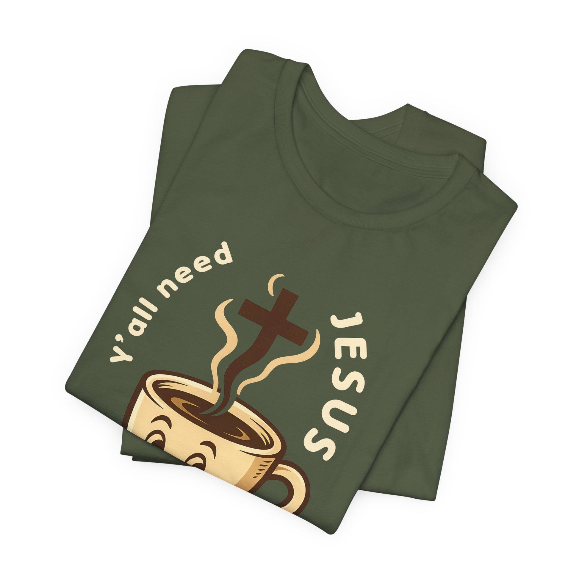 Green t-shirt with a graphic design featuring a coffee cup and cross, text 'Y'all need Jesus', on a white background.